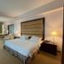 Oriental Crystal Hotel in Kajang guest room with king bed, desk, chairs, and curtained window