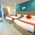 Legazpi Tourist Inn in Legazpi City: twin beds in a bright guest room with blue accent wall
