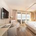 Seerose Resort & Spa in Meisterschwanden guest room with canopy bed and lake-view balcony