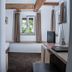 Hotel Hofgut Hohenkarpfen room in Hausen ob Verena with exposed beams, window seat, desk and TV