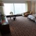 Shangmao International Hotel in Nanjing guest room with two beds, desk and large window view