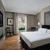 Protea Hotel by Marriott Bloemfontein guest room with king bed, wood floors, and window view