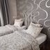 7th Mill apartments, Kranj: twin bed with patterned bedding, gray accent wall, and curtains in a guest room
