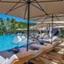 Wailea Beach Resort - Marriott, Maui poolside loungers and umbrellas overlooking a tropical infinity pool