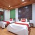 OYO 75353 Loy Chalet Resort room with two twin beds and wood-paneled ceiling in Nakhon Si Thammarat