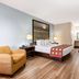 Guest room at Super 8 by Wyndham Florida City/Gateway to Keys/Everglades with bed, armchair, and desk