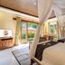 Ashoka Tree Resort at Tanggayuda, Ubud: canopy bed and terrace doors in a bright resort room
