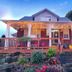 Serene Niagara Inn in Niagara Falls with a porch, string lights, and landscaped garden at dusk