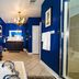 Stone Manor Boutique Inn in Lovettsville, bathroom with soaking tub, glass shower and blue walls
