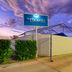 The Phoenix Artesian Spa Resort and Accommodation entrance in Moree with sign, gate and paved driveway