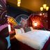 Mcmenamins Elks Temple Tacoma guest room with graffiti-style mural, white bed and hanging lights