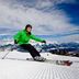 Skier on a snowy mountain slope with alpine views at Hotel Planaiblick in Schladming