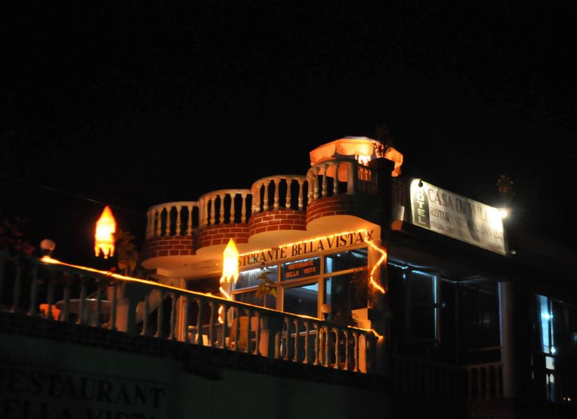 Hotel Casa di William in Khajurāho, lit rooftop terrace and balcony at night