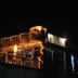 Hotel Casa di William in Khajurāho, lit rooftop terrace and balcony at night