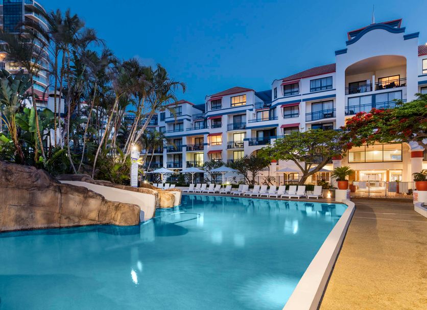 Oaks Gold Coast Calypso Plaza Suites in Coolangatta with a large outdoor pool and palm-lined resort courtyard