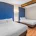 The Inn at Boatworks, Lake Tahoe room with two beds and wood-beam ceiling in Tahoe City