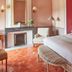 Château de Fonscolombe bedroom in Le Puy-Sainte-Réparade with fireplace and upholstered armchair