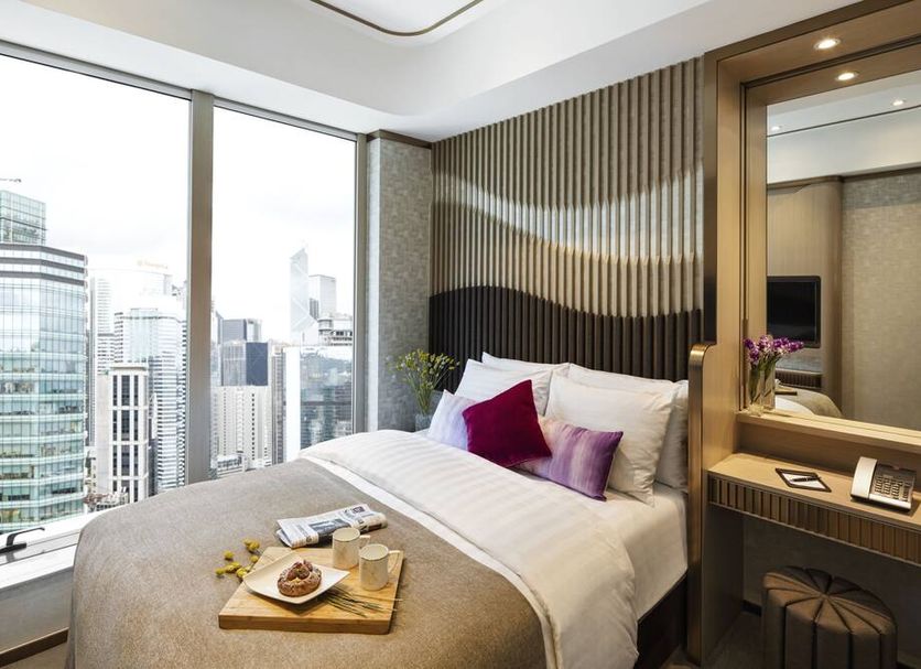 Burlington Hotel in Hong Kong guest room with city skyline view and large windows