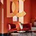 Hotel De Cambis, BW Premier Collection in Avignon lounge with red chairs, round tables, and large DC wall art