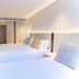 The Bauhinia Hotel - Central guest room in Hong Kong with two beds and sleek modern décor