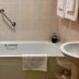 Ard na Breatha in Donegal bathroom with bathtub, shower curtain, grab bar, and sink