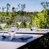 Auberge La Fontaine Aux Bretons in Pornic outdoor dining table set with wine glasses and garden view