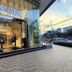 Golden Peak Hotel & Suites powered by Cocotel in Cebu City with a glass-front entrance at dusk