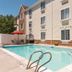 Outdoor pool at TownePlace Suites by Marriott Salt Lake City Layton in Layton beside the hotel exterior
