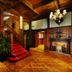 Moller Villa Hotel Shanghai grand wood-paneled lobby with red-carpeted staircase and chandelier