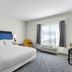 Hampton Inn & Suites Chicago Deer Park guest room with king bed, window and desk