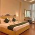 Hotel Devi Grand Katra guest room with king bed, sitting area and floor-to-ceiling windows