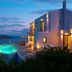Domes of Elounda, Autograph Collection in Elounda with illuminated seaside villas and infinity pool at dusk