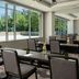 The Westin Reston Heights meeting room in Reston with tables, chairs, large windows and wall screen