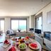 Euphoria Estate Messinia in Avia: sea-view suite with dining table set for breakfast and lounge seating