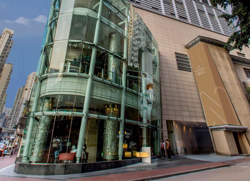 Nina Hotel Causeway Bay in Hong Kong, exterior of modern glass high-rise hotel on city street