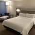 Holiday Inn Express & Suites Hermosa Beach guest room with king bed and lounge chair