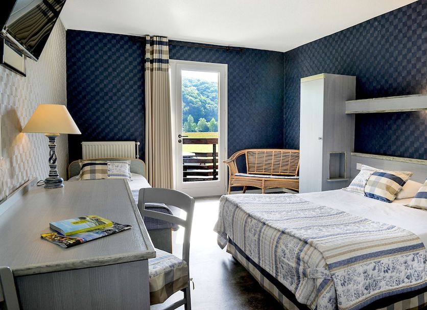 Logis Le Vieux Logis in Lestelle-Bétharram guest room with twin beds, desk, balcony door and mountain view