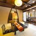 Miyako Gero Hot Spring tatami room with low table, floor cushions, and mountain-view seating area