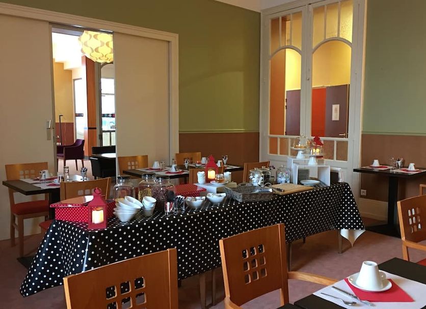 Residence Les Thermes in Luxeuil-les-Bains dining room with buffet table and tables set for breakfast