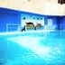 Golden Key Hotel, Accra indoor swimming pool with dolphin mural and blue-tiled water