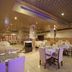 Hotel Chevron International Ludhiāna restaurant dining room with set tables and tiled floor
