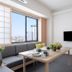 Mimaru Tokyo Asakusa Station room with city view, sofa, dining table and wall-mounted TV in Tokyo