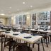 Wyndham Anaheim Hotel in Anaheim dining area with neatly set tables and large windows
