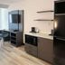 Studio 6 Suites Elkhart, IN room with bed, desk, TV, kitchenette, and mini fridge