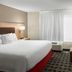 Towneplace Suites By Marriott Danville guest room with king bed, sofa, and window air conditioner