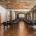 AC Hotel Fort Worth Downtown meeting room with rows of chairs, wood ceiling, and large windows