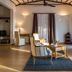 Konokono Beach Resort and Isaraya Over Water Villa in Michamvi, stylish suite with armchairs and sheer curtains