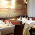 Hotel Marburger Hof restaurant dining area in Marburg with set tables and vineyard mural