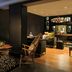 Renaissance Cincinnati Downtown Hotel lounge with dark decor, wood floors, seating area and bar in Cincinnati