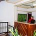 Hotel Bolivar Plaza in Manizales reception desk with staff member and wall-mounted TV
